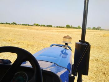 Vintage car on field against clear sky
