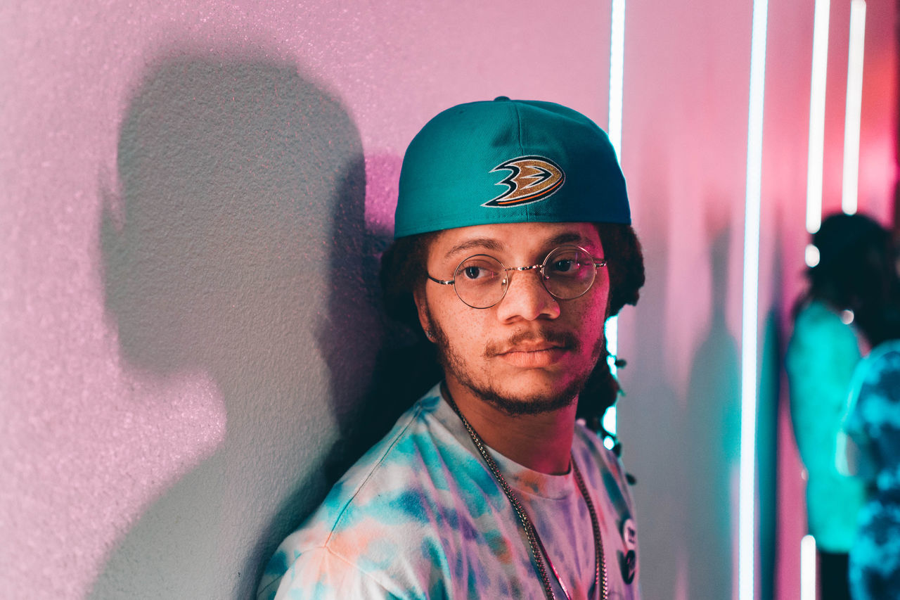 blue, portrait, adult, one person, looking at camera, headshot, men, red, clothing, indoors, glasses, person, human face, young adult, arts culture and entertainment, front view, pink, serious, beard