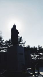 Low angle view of silhouette statue against sky