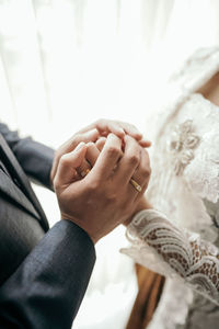 Midsection of couple holding hands