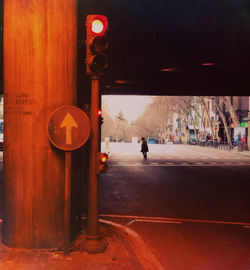 Rear view of a man standing on road