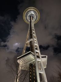 Low angle view of ferris wheel against cloudy sky