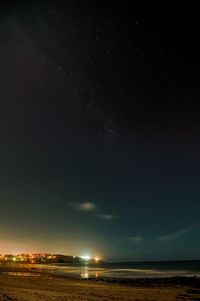 Scenic view of landscape against sky at night