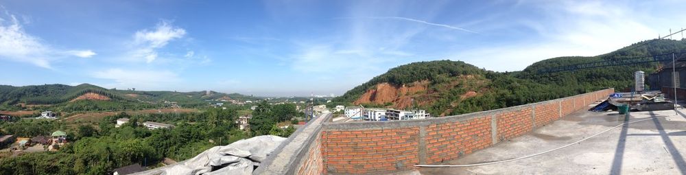 Panoramic view of buildings and mountains against sky