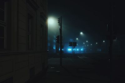 Illuminated street light in city at night