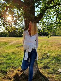 Full length of woman sitting on field