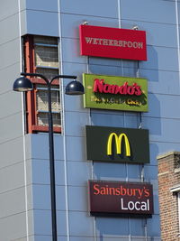 Low angle view of information sign on wall