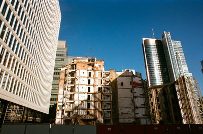 Low angle view of buildings against blue sky