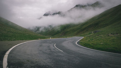 Empty road leading towards mountains