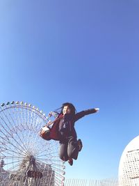 Low angle view of ferris wheel against clear sky