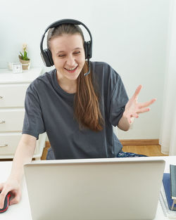 Smiling young woman using mobile phone