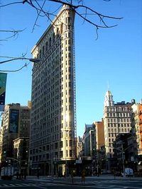 Low angle view of skyscrapers against blue sky