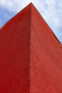 The photo shows a red corner of a modern building