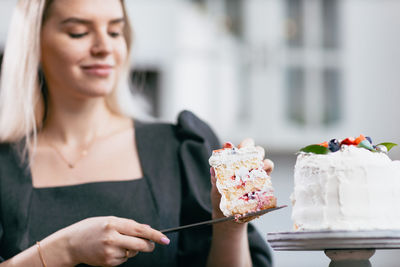 Portrait of smiling young woman having food