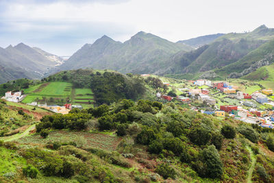 Scenic view of trees and mountains against sky