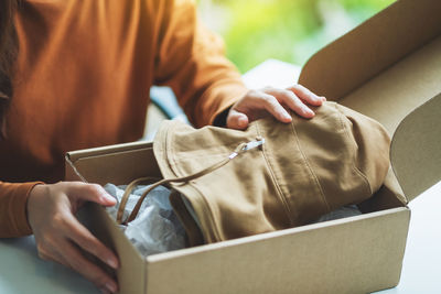 Midsection of man holding suitcase