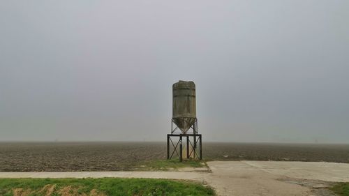 Lifeguard hut on beach against sky