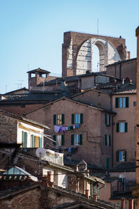 Buildings in city against clear sky