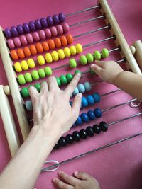 High angle view of hands holding multi colored playing