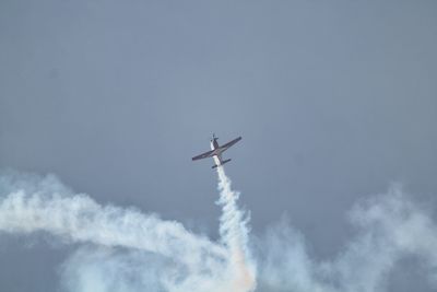 Low angle view of airplane flying in sky