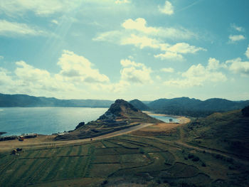 Scenic view of land and sea against sky