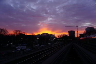 Railroad tracks against cloudy sky