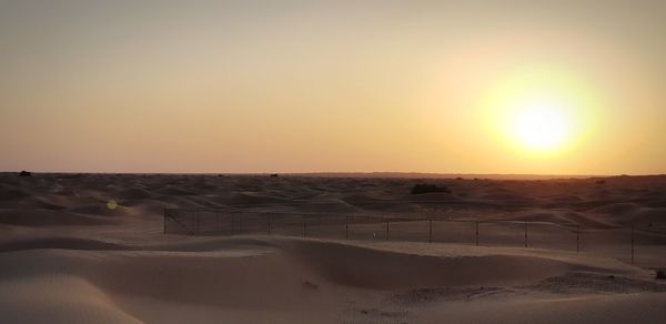 Scenic view of desert against sky during sunset