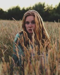 Portrait of young woman in field