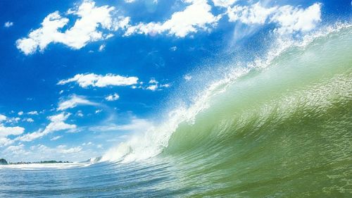 Surface level of wave against blue sky