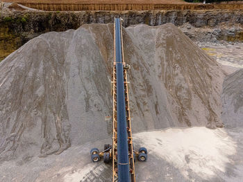 A massive pile of gravel has formed from all the rock transported by this conveyor