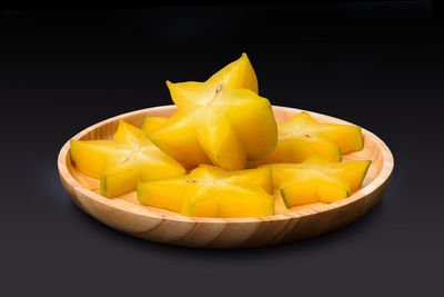 Close-up of yellow fruit against black background