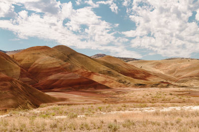 View of desert against cloudy sky