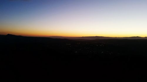 Silhouette landscape against clear sky