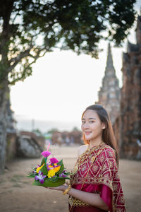 Portrait of woman in traditional clothing standing outdoors