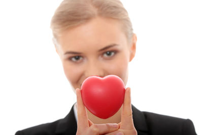 Portrait of a young woman holding heart