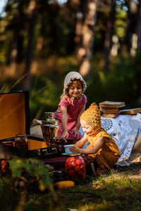 Two little girls are playing tea party