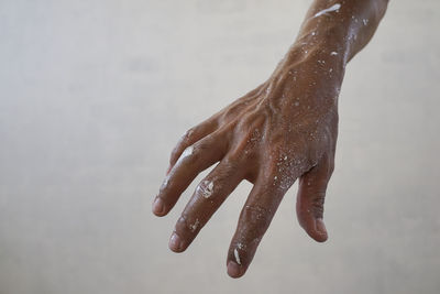 Close-up of hand on wet floor