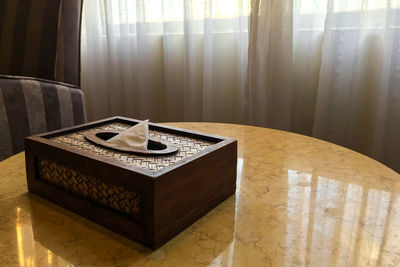 Low angle view of telephone booth on table at home