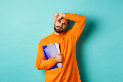 Man standing against blue background