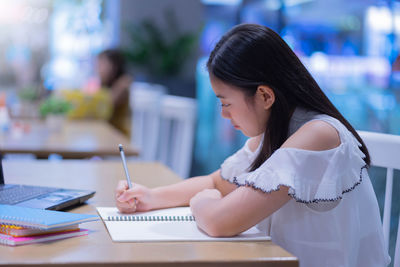Woman sitting on table