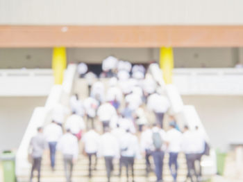 Rear view of people walking on floor