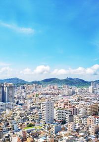 High angle view of townscape against blue sky