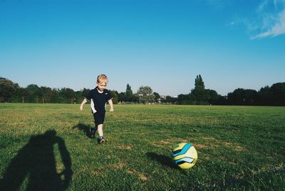 Full length of girl standing on grassy field