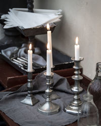 Close-up of lit candles on table