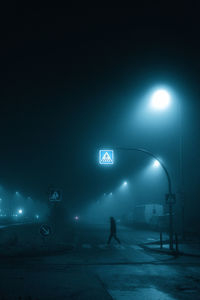Man walking on road at night