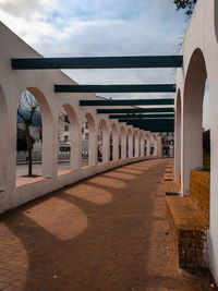 Corridor of historic building against sky