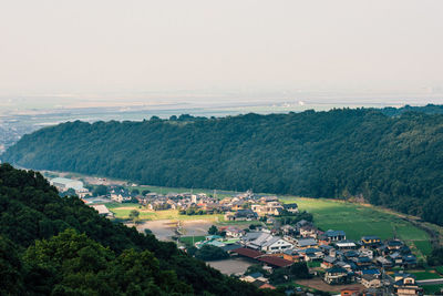 High angle view of houses on field against sky