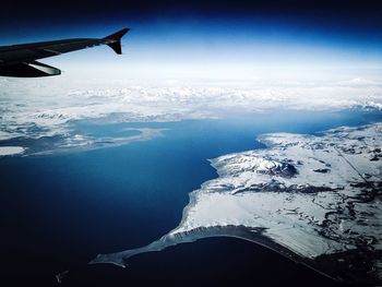 Aerial view of landscape against cloudy sky