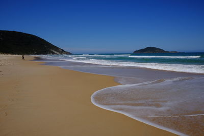 Scenic view of beach against clear sky