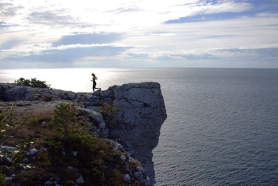 View of woman running on cliff